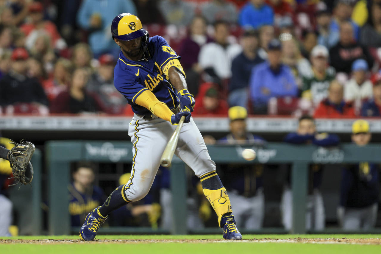 Milwaukee Brewers' Andrew McCutchen hits an RBI-force out during the fifth inning of a baseball gam...