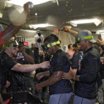 
              Houston Astros players celebrate in the clubhouse after clinching the AL West title with a win over the Tampa Bay Rays during a baseball game Monday, Sept. 19, 2022, in St. Petersburg, Fla. (AP Photo/Chris O'Meara)
            