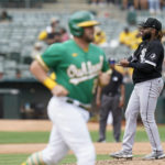 
              Chicago White Sox starting pitcher Johnny Cueto, right, looks toward home plate after walking Oakland Athletics' Stephen Vogt, foreground, during the fifth inning of a baseball game in Oakland, Calif., Sunday, Sept. 11, 2022. (AP Photo/Godofredo A. Vásquez)
            
