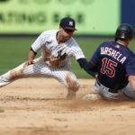 
              Minnesota Twins third baseman Gio Urshela (15) beats the tag of New York Yankees shortstop Isiah Kiner-Falefa (12) for a stolen base at second during the sixth inning of a baseball game Monday, Sept. 5, 2022, in New York. (AP Photo/Noah K. Murray)
            
