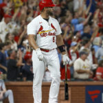 
              St. Louis Cardinals' Albert Pujols watches his two-run home run against the Cincinnati Reds during the sixth inning of a baseball game Friday, Sept. 16, 2022, in St. Louis. (AP Photo/Scott Kane)
            
