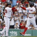 
              Boston Red Sox's Xander Bogaerts celebrates with J.D. Martinez (28) after scoring on a double by Rafael Devers during the first inning of a baseball game against the Texas Rangers, Saturday, Sept. 3, 2022, in Boston. (AP Photo/Michael Dwyer)
            