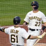 
              Pittsburgh Pirates' Kevin Newman (27) is greeted by Jason Delay after scoring on a sacrifice fly by Michael Chavis off New York Mets starting pitcher Taijuan Walker during the second inning of a baseball game in Pittsburgh, Tuesday, Sept. 6, 2022. (AP Photo/Gene J. Puskar)
            