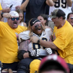 
              Appalachian State offensive lineman Bucky Williams (62) reacts with fans after the team's 17-14 win over Texas A&M in an NCAA college football game Saturday, Sept. 10, 2022, in College Station, Texas. (AP Photo/Sam Craft)
            
