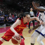
              China's Wang Siyu attempts to push past United States' Jewell Loyd during their game at the women's Basketball World Cup in Sydney, Australia, Saturday, Sept. 24, 2022. (AP Photo/Mark Baker)
            