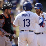 
              Los Angeles Dodgers' Justin Turner, right, celebrates his three-run home run at home plate with Max Muncy (13) during the fifth inning of a baseball game against the San Francisco Giants Wednesday, Sept. 7, 2022, in Los Angeles. (AP Photo/Marcio Jose Sanchez)
            