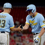 
              Milwaukee Brewers' Hunter Renfroe is congratulated by first base coach Quintin Berry (23) after hitting an RBI single during the eighth inning of a baseball game against the St. Louis Cardinals Tuesday, Sept. 13, 2022, in St. Louis. (AP Photo/Jeff Roberson)
            