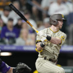 
              San Diego Padres' Jake Cronenworth follows the flight of his RBI-single off Colorado Rockies starting pitcher Chad Kuhl in the third inning of a baseball game Saturday, Sept. 24, 2022, in Denver. (AP Photo/David Zalubowski)
            