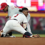 
              Atlanta Braves' Ozzie Albies (1) slides in safely against Philadelphia Phillies second baseman Jean Segura in the fourth inning of a baseball game, Saturday, Sept. 17, 2022, in Atlanta. (AP Photo/Brynn Anderson)
            
