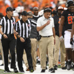 
              Oklahoma State head coach Mike Gundy speaks with game officials while walking the sideline during the first quarter of an NCAA college football game against Arizona State, Saturday, Sept. 10, 2022, in Stillwater, Okla. (AP Photo/Brody Schmidt)
            