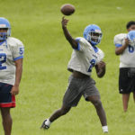 
              Murrah High School football quarterback Odarrius Harris, (2) passes during practice, Wednesday, Aug. 31, 2022, in Jackson, Miss. The city's low water pressure concerns football coach Marcus Gibson, as it limits his options for washing practice uniforms, towels and other gear his players wear. The recent flood worsened Jackson's longstanding water system problems. (AP Photo/Rogelio V. Solis)
            