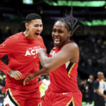 
              Las Vegas Aces guard Chelsea Gray, right, celebrates with guard Kierstan Bell at the end of the team's win over the Seattle Storm in Game 4 of a WNBA basketball playoff semifinal Tuesday, Sept. 6, 2022, in Seattle. The Aces advanced to the WNBA finals. (AP Photo/Lindsey Wasson)
            