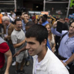 
              U.S. Open men's singles tennis champion Carlos Alcaraz walks in Times Square, Monday, Sept. 12, 2022, in New York. (AP Photo/Yuki Iwamura)
            