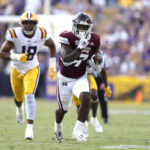 
              Mississippi State running back Jo'quavious Marks (7) runs the ball past LSU defensive end BJ Ojulari (18) to score a touchdown during the first half of an NCAA college football game in Baton Rouge, La., Saturday, Sept. 17, 2022. (AP Photo/Tyler Kaufman)
            