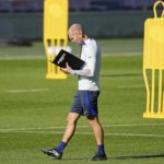 
              US head coach Gregg Berhalter reads in a book during a training session of the US soccer team in Cologne, Germany, prior to a friendly match against Japan, Thursday, Sept. 22, 2022. The USA will play Japan in a friendly soccer match as part of the KIRIN CHALLENGE CUP to prepare for the World Cup in Qatar in Duesseldorf on Friday. (AP Photo/Martin Meissner)
            