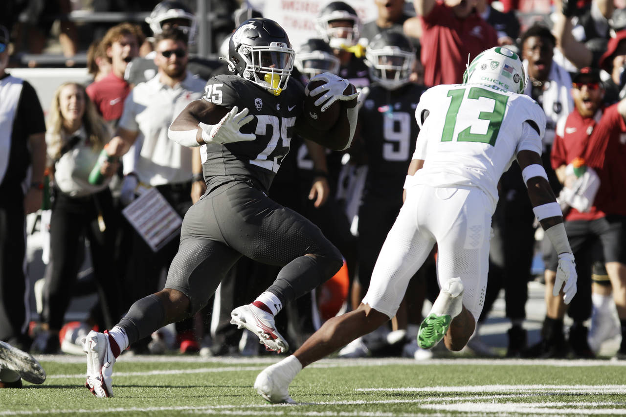 Washington State running back Nakia Watson (25) carries the ball while pursued by Oregon defensive ...