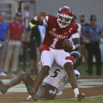 
              Arkansas quarterback KJ Jefferson (1) is sacked by Cincinnati defensive back Ja'Quan Sheppard (5) during the second half of an NCAA college football game Saturday, Sept. 3, 2022, in Fayetteville, Ark. (AP Photo/Michael Woods)
            
