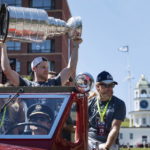 
              Colorado Avalanche's Nathan MacKinnon lifts the NHL hockey Stanley Cup during a parade in Halifax, Nova Scotia, on Saturday, Aug. 20, 2022. (Darren Calabrese/The Canadian Press via AP)
            