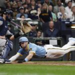 
              Milwaukee Brewers' Garrett Mitchell slides safely past New York Yankees' Kyle Higashioka to score a run during the fifth inning of a baseball game Saturday, Sept. 17, 2022, in Milwaukee. (AP Photo/Aaron Gash)
            