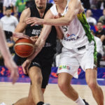 
              Germany's Franz Wagner, left, and Lithuania's Arnas Butkevicius fight for the ball during the Eurobasket preliminary round Group B match between Lithuania and Germany in Cologne, Germany, Sunday, Sept. 4, 2022. (Marius Becker/dpa via AP)
            
