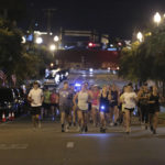 
              Runners make their way down Main Street in Tupelo, Miss. as they hold their "Liza's Lights" run early Friday morning, Spet. 9, 2022, in Tupelo Miss., to remember Eliza Fletcher, who was abducted and murdered while she was running in the early morning hours in Memphis, Tenn. (Thomas Wells/The Northeast Mississippi Daily Journal via AP)
            