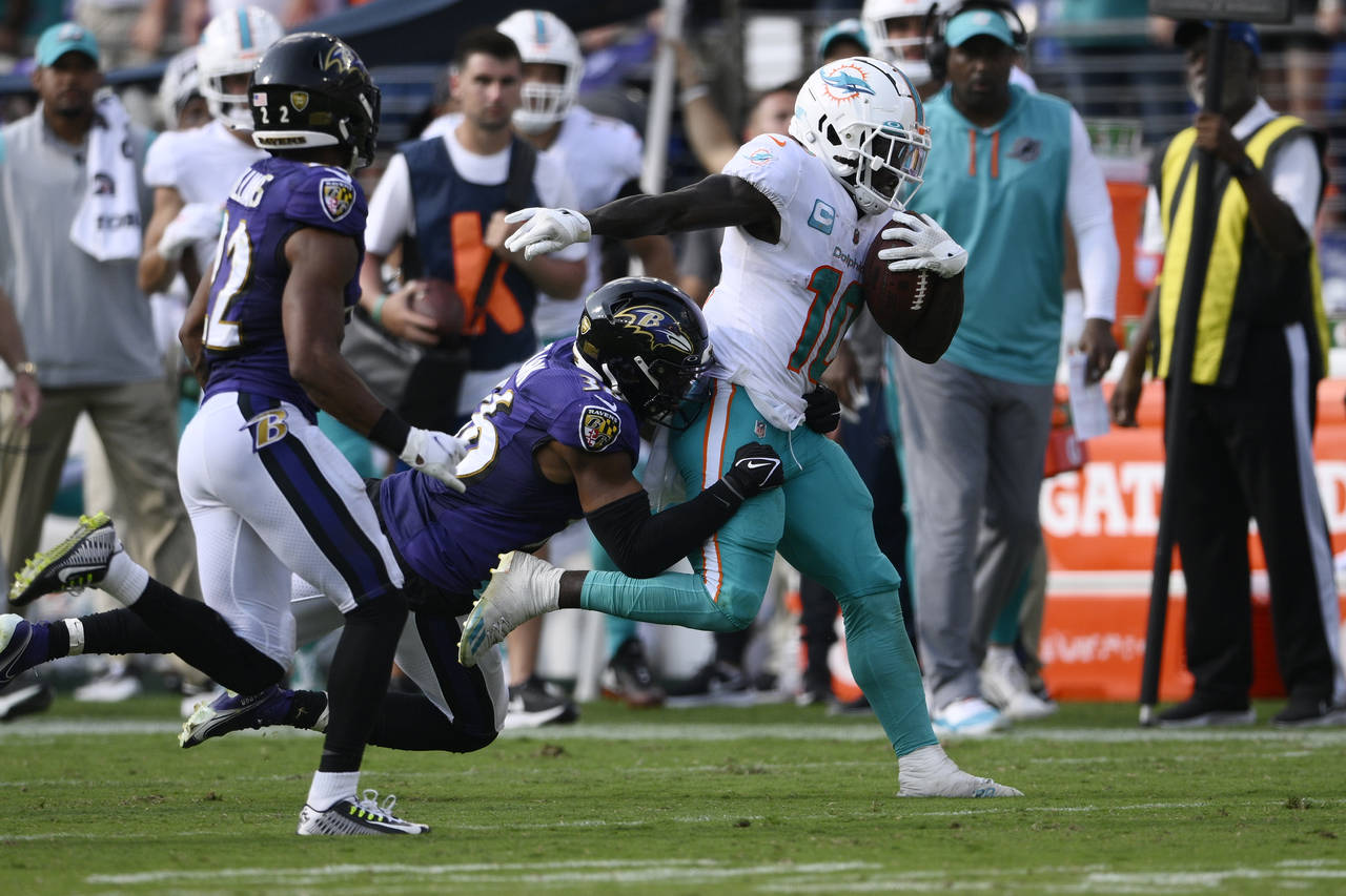 Baltimore Ravens safety Chuck Clark (36) tackles Miami Dolphins wide receiver Tyreek Hill (10) duri...