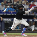 
              Miami Marlins' Miguel Rojas follows through on a double during the second inning of the team's baseball game against the New York Mets, Friday, Sept. 9, 2022, in Miami. (AP Photo/Marta Lavandier)
            