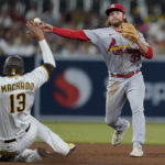 
              St. Louis Cardinals second baseman Brendan Donovan throws to first for the double play after forcing out San Diego Padres' Manny Machado during the fifth inning of a baseball game Tuesday, Sept. 20, 2022, in San Diego. Brandon Drury was out at first. (AP Photo/Gregory Bull)
            