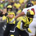 
              Oregon quarterback Bo Nix (10) looks for a receiver during the second quarter of the team's NCAA college football game against Eastern Washington on Saturday, Sept. 10, 2022, in Eugene, Ore. (AP Photo/Andy Nelson)
            