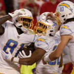 
              Los Angeles Chargers wide receiver Mike Williams, left, is congratulated by teammates Austin Ekeler and Justin Herbert (10) after scoring during the second half of an NFL football game Kansas City Chiefs Thursday, Sept. 15, 2022, in Kansas City, Mo. (AP Photo/Charlie Riedel)
            