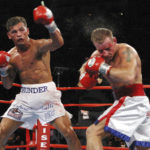
              FILE - Arturo Gatti, left, punches Mickey Ward during the junior welterweight fight in Atlantic City, N.J., on Saturday, June 7, 2003. The fight lasted the the full 10 rounds and Gatti defeated Ward by a unanimous decision This was the third fight between the fighters and both fighters ended up in hospital trauma units. (AP Photo/Donna Connor, File)
            