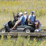 
              Charl Schwartzel, right, rides a cart on his way to the third tee box during the shotgun-start in the second round of the LIV Golf Invitational-Chicago tournament Saturday, Sept. 17, 2022, in Sugar Grove, Ill. (Joe Lewnard/Daily Herald via AP)
            