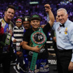 
              Isaac Cruz, center, celebrates after winning a WBC world lightweight title eliminator boxing match against Eduardo Ramirez, Sunday, Sept. 4, 2022, in Los Angeles. (AP Photo/Ashley Landis)
            