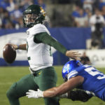 
              Baylor quarterback Blake Shapen (12) looks to pass the ball as BYU defensive lineman Fisher Jackson (53) applies pressure during the first half of an NCAA college football game Saturday, Sept. 10, 2022, in Provo, Utah. (AP Photo/George Frey)
            