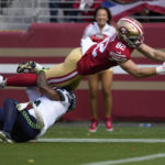 
              San Francisco 49ers tight end Ross Dwelley (82) dives toward the endzone to score over Seattle Seahawks safety Quandre Diggs during the first half of an NFL football game in Santa Clara, Calif., Sunday, Sept. 18, 2022. (AP Photo/Tony Avelar)
            