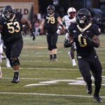 
              Wake Forest running back Christian Turner (0) runs for a touchdown against VMI during the first half of an NCAA college football game in Winston-Salem, N.C., Thursday, Sept. 1, 2022. (AP Photo/Chuck Burton)
            