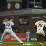 
              Atlanta Braves first baseman Matt Olson (28) is unable to catch a throw from second baseman Vaughn Grissom as San Francisco Giants' Thairo Estrada (39), who singled, reached first safely on the throwing error during the fifth inning of a baseball game in San Francisco, Monday, Sept. 12, 2022. Giants' Mike Yastrzemski scored on the play. (AP Photo/Godofredo A. Vásquez)
            