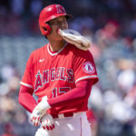 
              Los Angeles Angels designated hitter Shohei Ohtani changes out his hitting gloves for base-running gloves while on first base during the third inning of a baseball game against the Seattle Mariners in Anaheim, Calif., Sunday, Sept. 18, 2022. (AP Photo/Alex Gallardo)
            