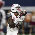 
              Arkansas wide receiver Warren Thompson (84) catches a pass during the first half of the team's NCAA college football game against Texas A&M Saturday, Sept. 24, 2022, in Arlington, Texas. Thompson ran for a touchdown on the play. (AP Photo/Brandon Wade)
            