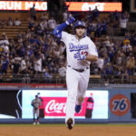 
              Los Angeles Dodgers' Max Muncy gestures as he heads to third after hitting a two-run home run during the third inning of a baseball game against the San Francisco Giants Tuesday, Sept. 6, 2022, in Los Angeles. (AP Photo/Mark J. Terrill)
            