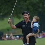 
              FILE - Jimmy Walker celebrates with his son Beckett after winning the PGA Championship golf tournament at Baltusrol Golf Club in Springfield, N.J., on July 31, 2016. Walker earned a full PGA Tour card for the season that starts Thursday, Sept. 15, 2022, because of all the LIV Golf defections. Walker had walked away from golf in April. (AP Photo/Mike Groll, File)
            
