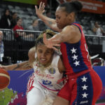 
              Puerto Rico's Arella Guirantes tries to get the ball past United States' Betnijah Laney at the women's Basketball World Cup in Sydney, Australia, Friday, Sept. 23, 2022. (AP Photo/Mark Baker)
            