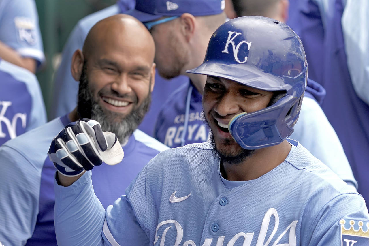 Kansas City Royals' Edward Olivares celebrates in the dugout after hitting a solo home run during t...