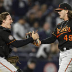
              Baltimore Orioles pitcher DL Hall (49) celebrates with Adley Rutschman after the team's 2-1 win in a baseball game against the New York Yankees on Friday, Sept. 30, 2022, in New York. (AP Photo/Adam Hunger)
            