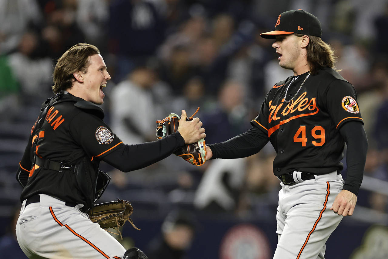 Baltimore Orioles pitcher DL Hall (49) celebrates with Adley Rutschman after the team's 2-1 win in ...
