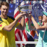 
              John Peers, left, and Storm Sanders, of Australia, hold up the championship trophy after winning the mixed doubles final against Kirsten Flipkens, of Belgium, and Edouard Roger-Vasselin, of France, at the U.S. Open tennis championships, Saturday, Sept. 10, 2022, in New York. (AP Photo/Matt Rourke)
            