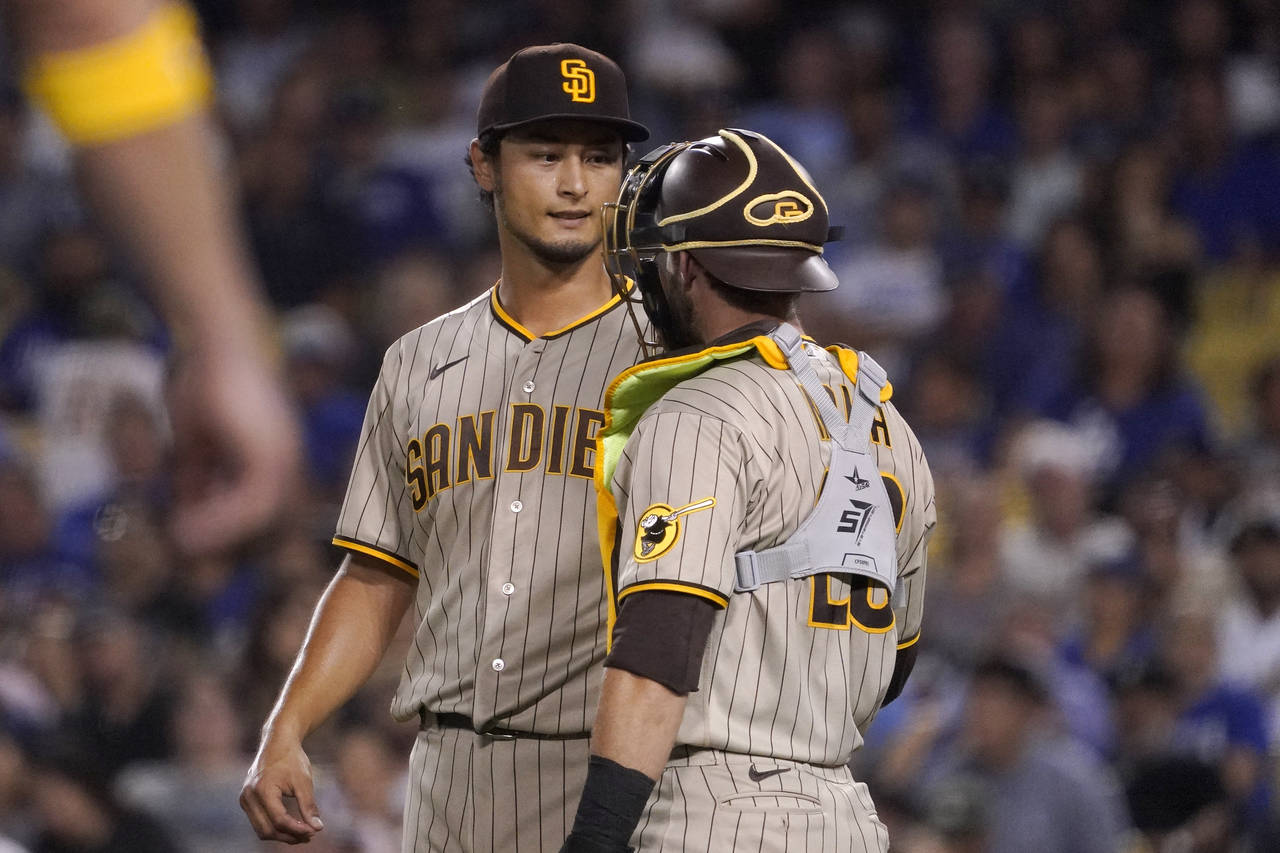San Diego Padres starting pitcher Yu Darvish, left, talks with catcher Austin Nola during the third...