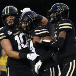 
              Vanderbilt wide receiver Will Sheppard (14) celebrates with tight end Gavin Schoenwald (10) and quarterback Mike Wright (5) after catching a pass for a touchdown against Elon in the first half of an NCAA college football game Saturday, Sept. 3, 2022, in Nashville, Tenn. (AP Photo/Mark Zaleski)
            