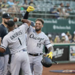 
              Chicago White Sox's Yoán Moncada (10) celebrates with Elvis Andrus (1) after hitting a solo home run against the Oakland Athletics during the first inning of a baseball game in Oakland, Calif., Thursday, Sept. 8, 2022. (AP Photo/Godofredo A. Vásquez)
            