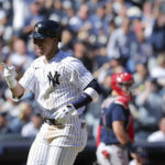 
              New York Yankees' Oswaldo Cabrera gestures after scoring on his home run as Boston Red Sox catcher Reese McGuire waits during the fourth inning a baseball game Saturday, Sept. 24, 2022, in New York. (AP Photo/Jessie Alcheh)
            